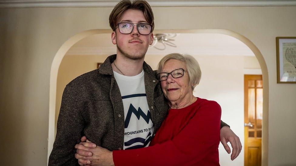 Zac Roberts and his grandmother hugging as they face the camera