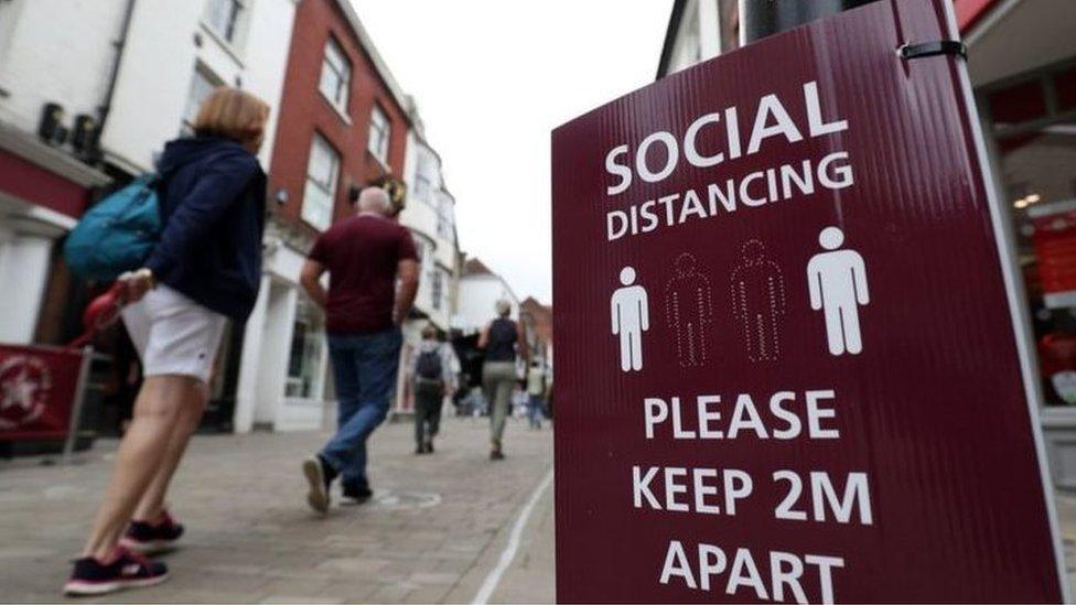 Bolton town centre with social distancing sign