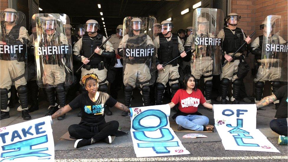 Parris Wallace (left) amid protests.