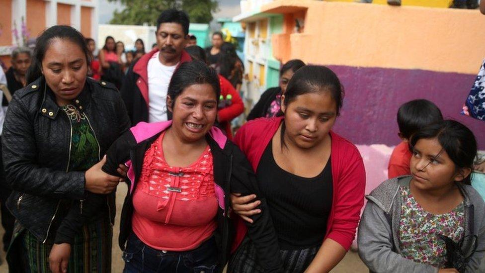 Gloria Perez (c) mourns her 14-year-old sister, Ana Roselia, who died in a fire at a Guatemalan children's home