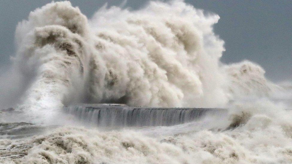 Waves crashing into a seafront