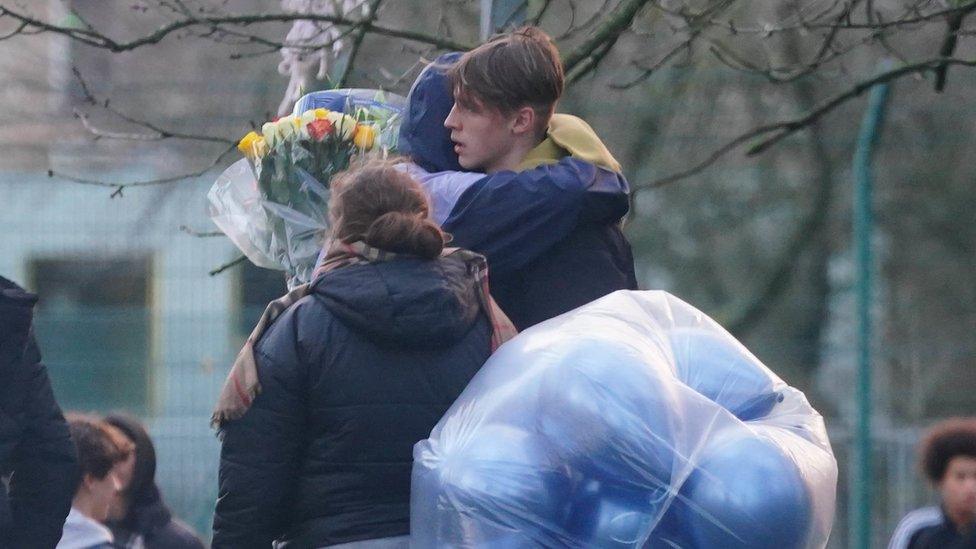 People hug at Harry Pitman vigil