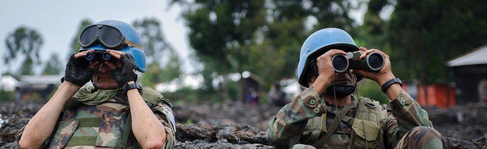 Peacekeepers of the UN mission in DR Congo surveying the horizon with binocs