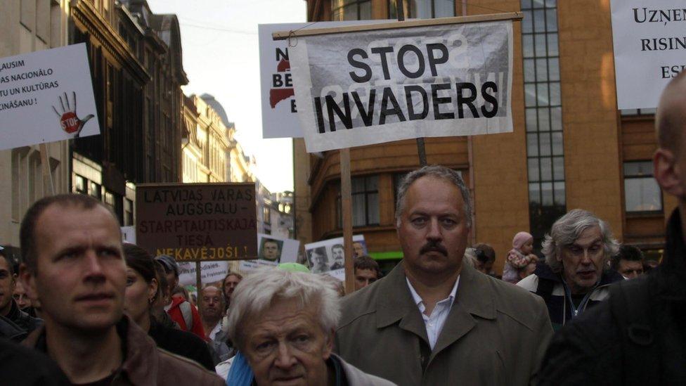 Participants take part in a rally against migrant quotes organized by the national Union Justice and society "Fatherland Defenders", in Riga, Latvia, 22 September 2015.