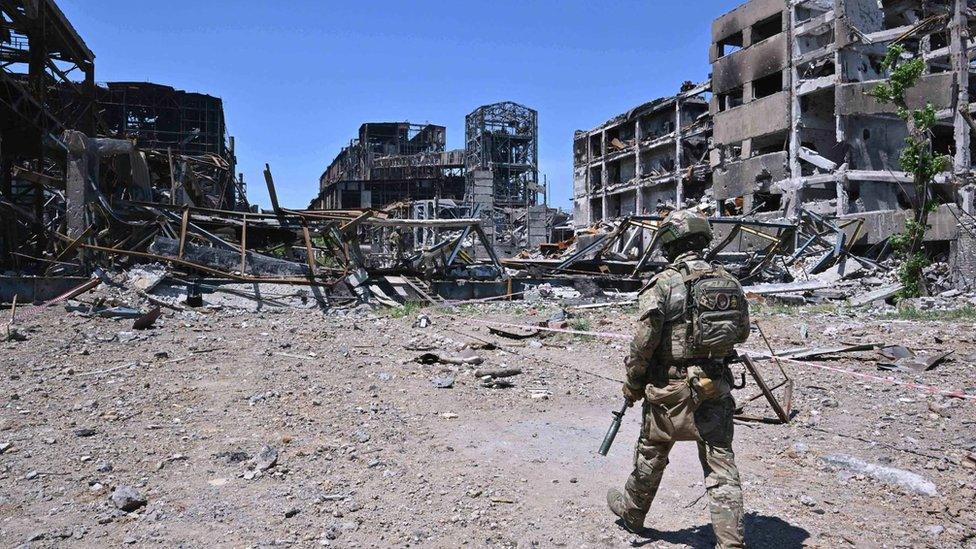 A Russian serviceman patrols near Akhmetov's Azovstal steel plant in Mariupol