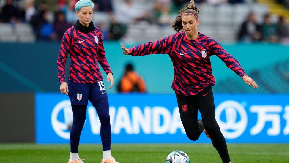 Alex Morgan and Megan Rapinoe warming up