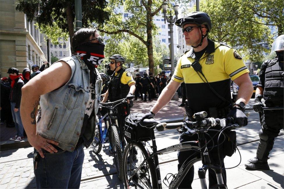 Police facing off with a protester