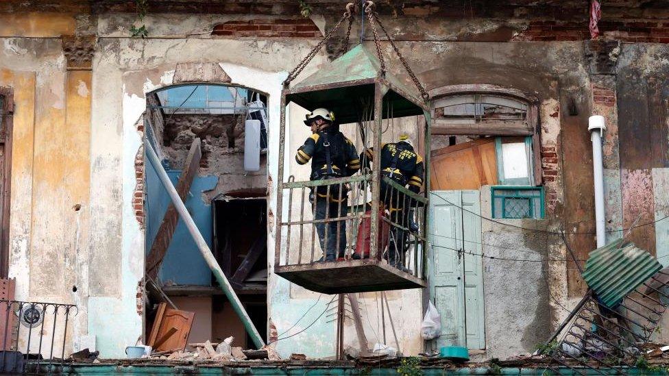 Rescuers work on the site of a collapsed building in Havana, Cuba, 04 October 2023.