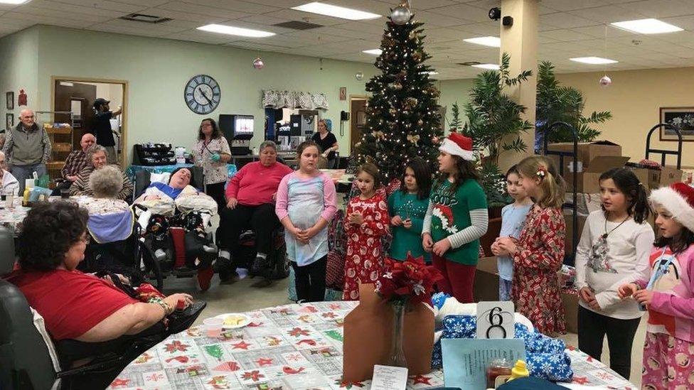 Girls scouts sang carols to residents at Fort Hudson nursing home on Friday when they received their bags