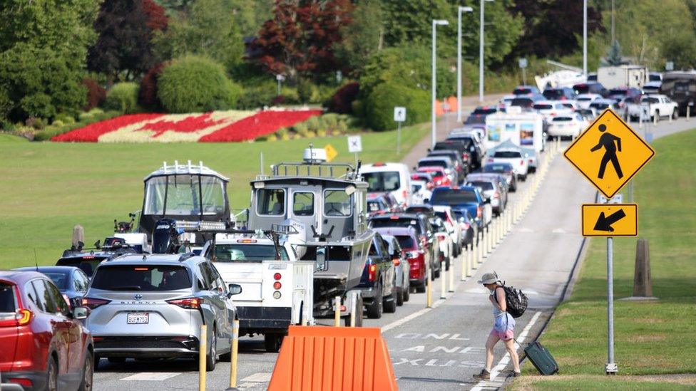 Cars line up at Canadian side of the border between Canada and the United States, near Seattle, Washington and Vancouver, British Columbia on August 9, 2021.