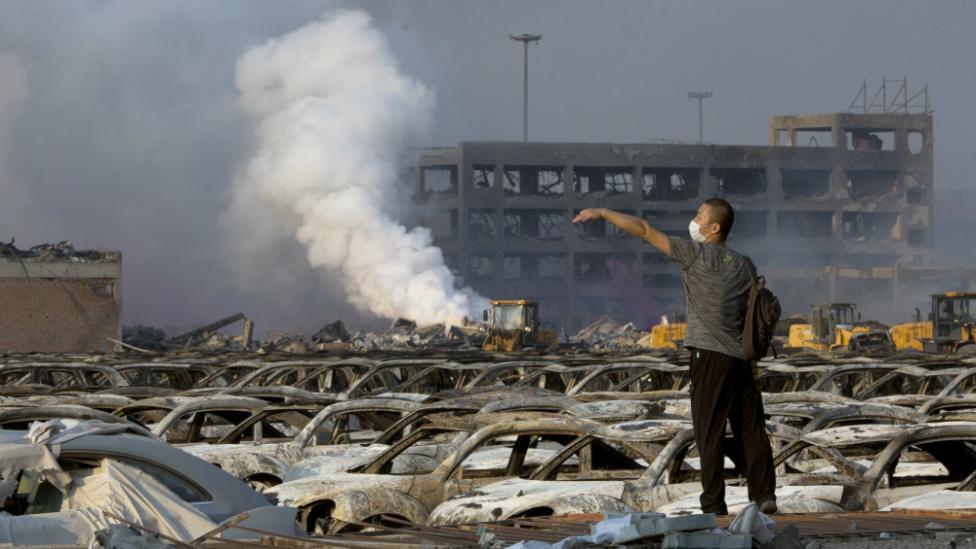 A man walks through the site of an explosion at a warehouse in northeastern China"s Tianjin municipality - 13 August 2015