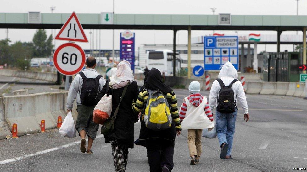 Migrants walk to the Austrian border near the town of Hegyeshalom, Hungary