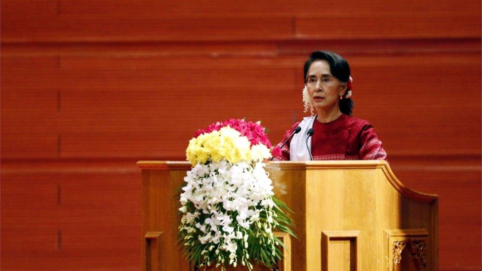 Aung San Suu Kyi speaking at a podium