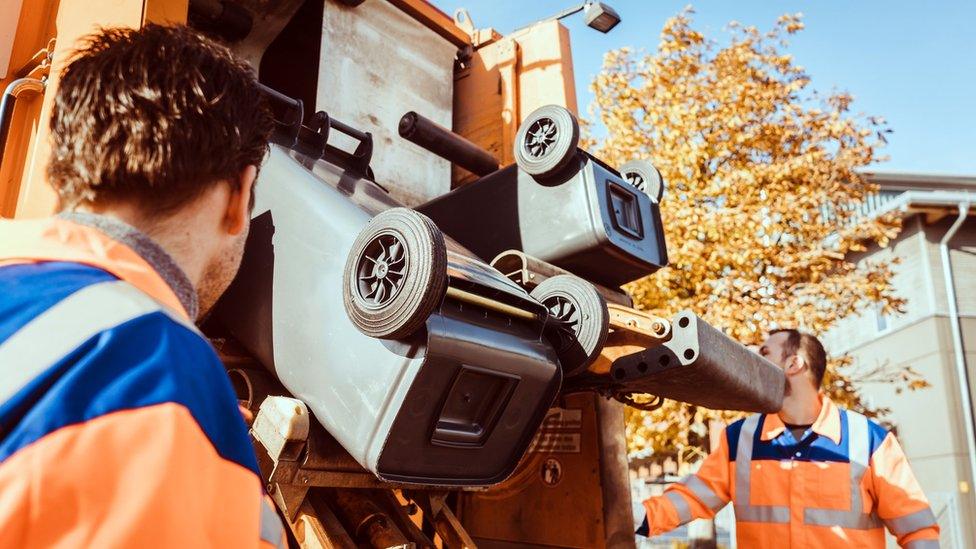 Refuse workers emptying a bin into the lorry