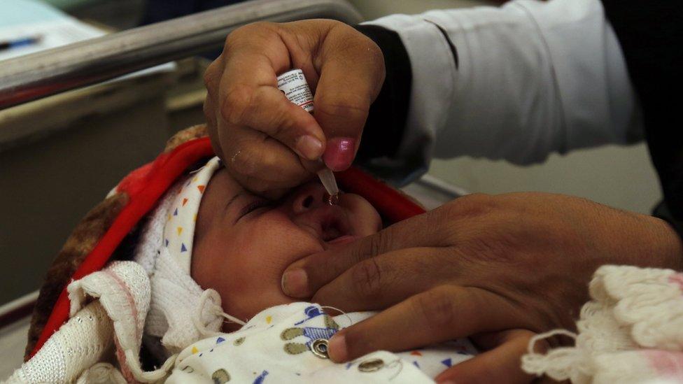 A Yemeni medic administers a polio vaccine to a child at a health centre in Sanaa, Yemen (23 October 2017)