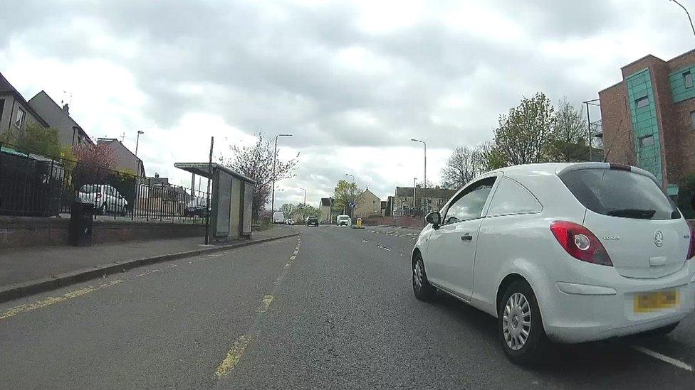 Car passing cyclist