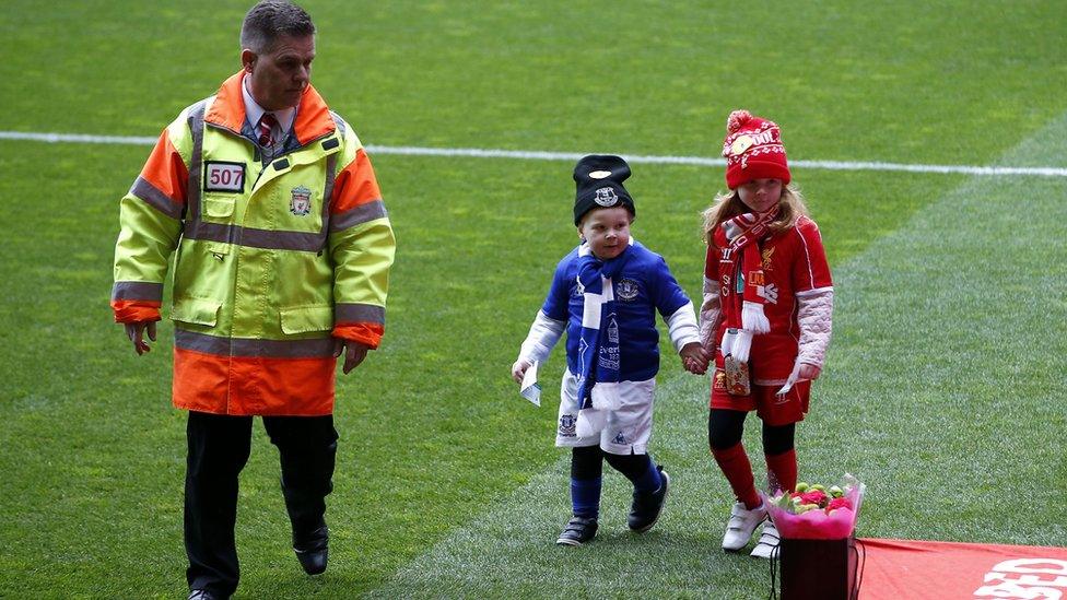 Girl and boy in red and blue kits