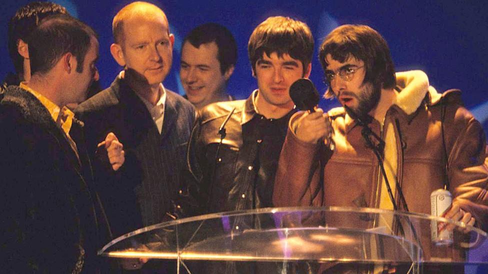 Oasis and Alan McGee at the Brit Awards in 1996