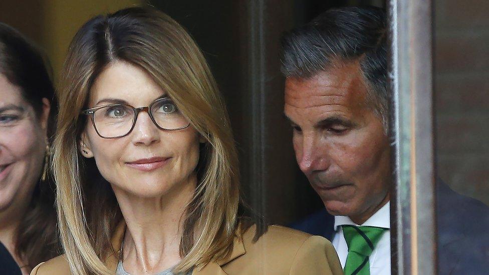 US actress Lori Loughlin (L) and husband Mossimo Giannulli (R) leave court in Boston, Massachusetts, on 3 April 2019