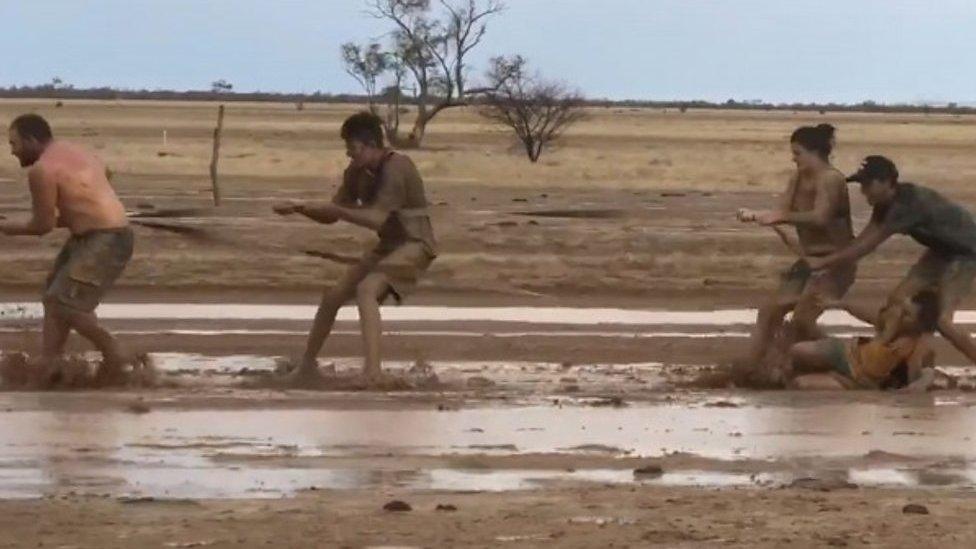 Australians play in mud