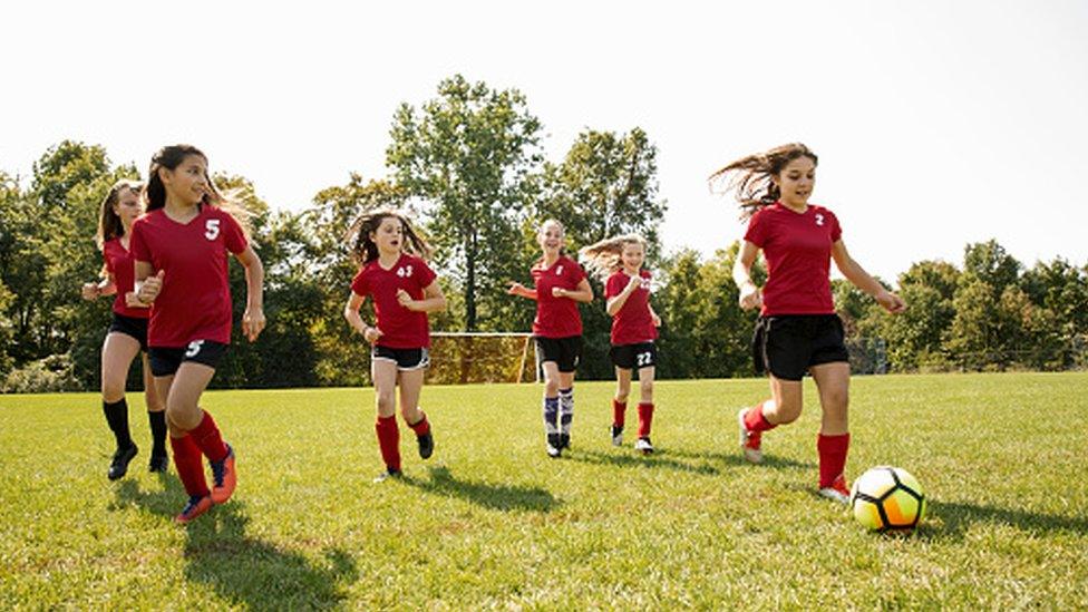 group of girls playing football