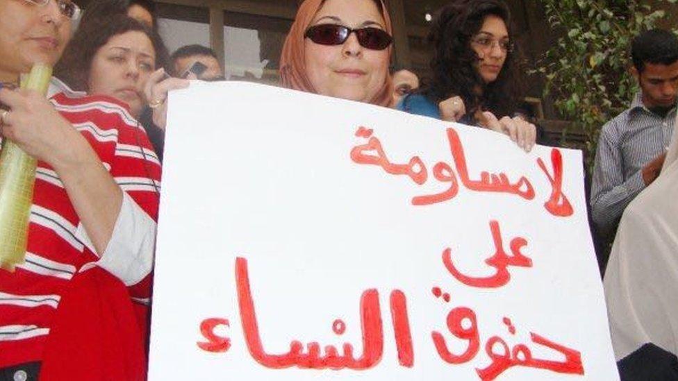 Esraa Abdel Fattah holds a sign reading: "No negations on women rights"