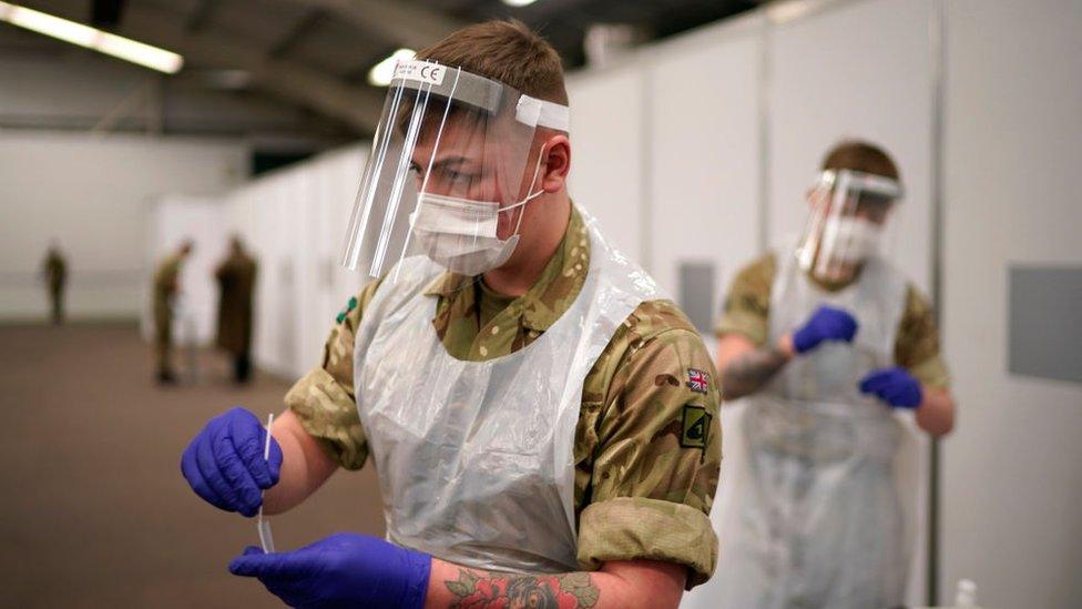 A soldier carrying out a covid-19 test