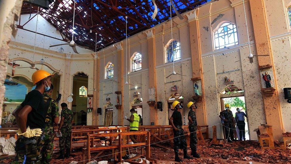 Security personnel inspect the interior of St. Sebastian"s Church in Negombo