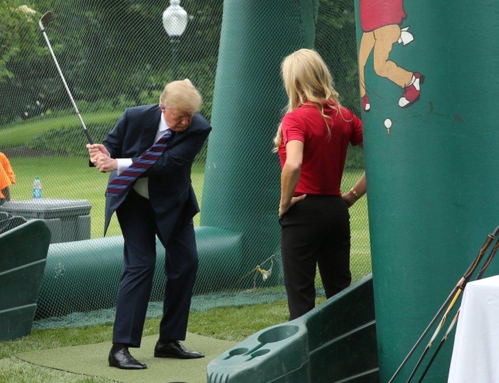 Mr Trump swung a golf club during the event on the White House lawn