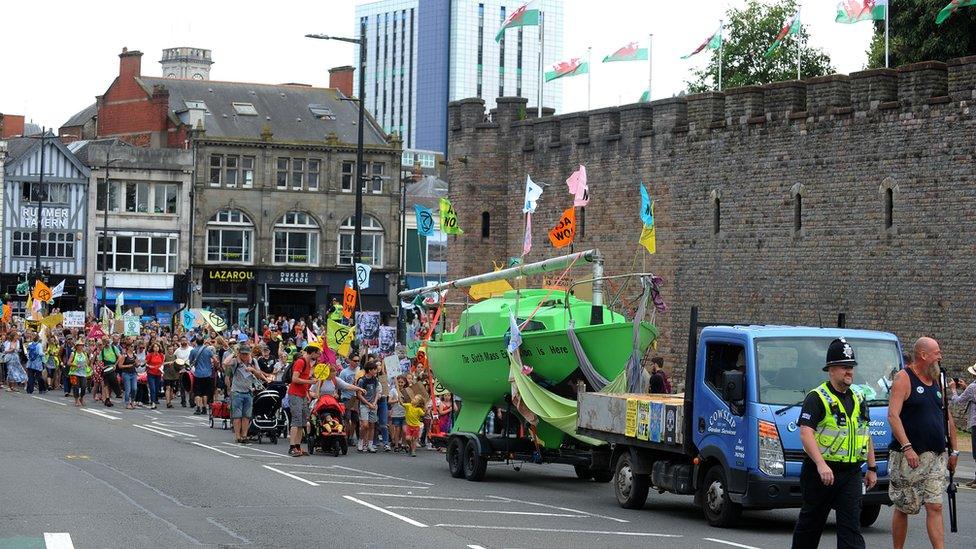 The green boat which was in the middle of the street since Monday was towed to City Hall on Wednesday afternoon