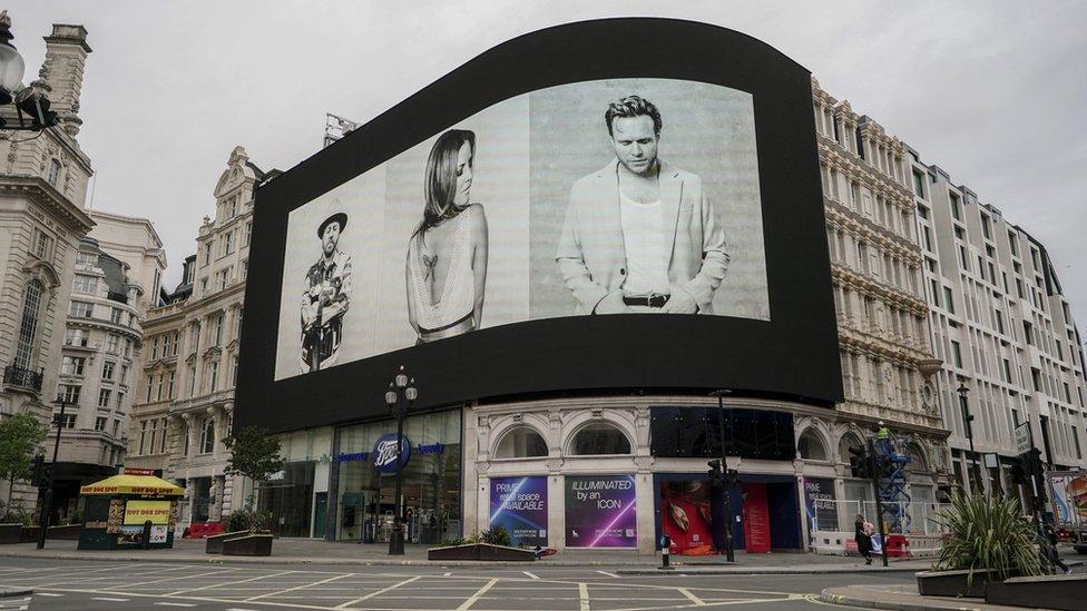 Piccadilly Lights, showing photographs of people with their eyes closed