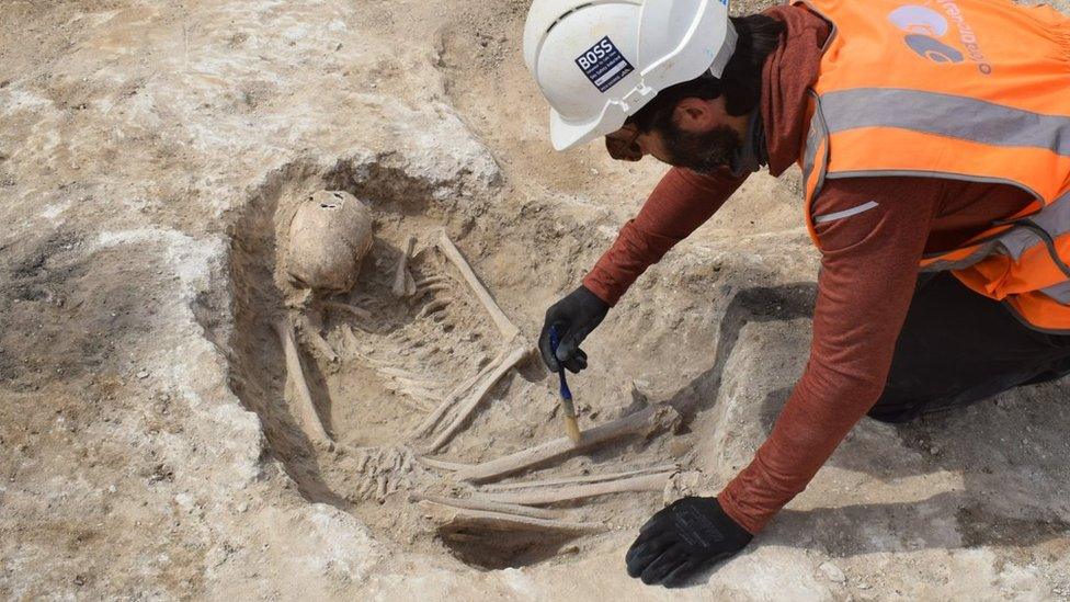 Archaeologist uncovering one of the burial sites in Cambridge