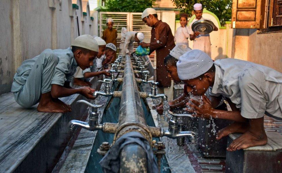 Indian Muslim children are seen performing ablutions before offering prayers in a mosque during the first day of the holy fasting month of Ramadan in Patiala district of Punjab.