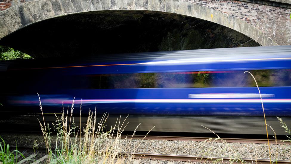 Train travelling at speed through tunnel