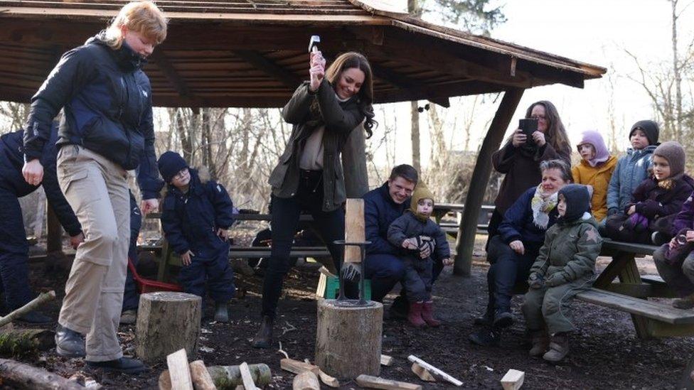 Kate chopping a log