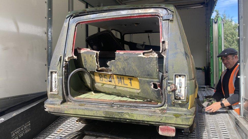 The Reliant Rialto loaded onto the back of a recovery vehicle, with damage to its rear end