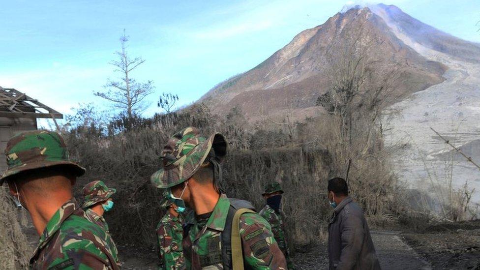 Indonesian soldiers search an area following a deadly eruption of Mount Sinabung volcano in Gamber Village, North Sumatra, Indonesia 22 May 2016