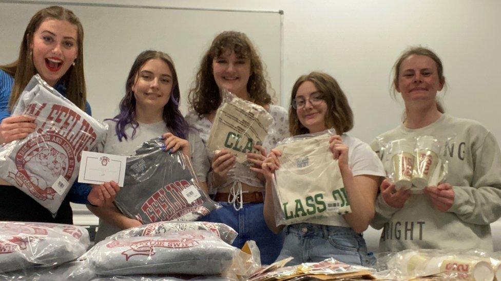 Students holding up gifts sent by Taylor Swift