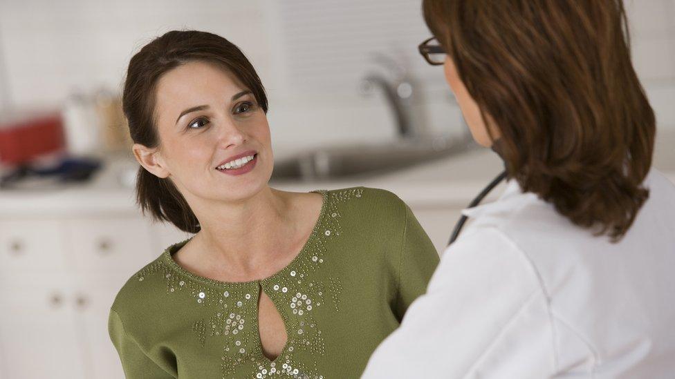 Female patient chatting to gynaecologist