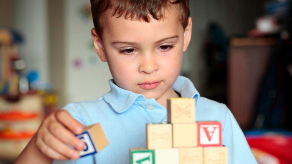 A young boy with building blocks