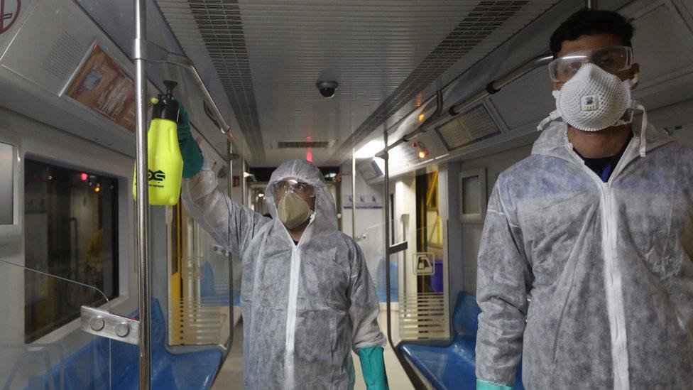 Tehran Municipality workers clean a metro train to avoid the spread of the COVID-19 illness on February 26, 2020.