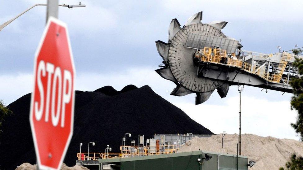 A stop sign pictured beside mine equipment