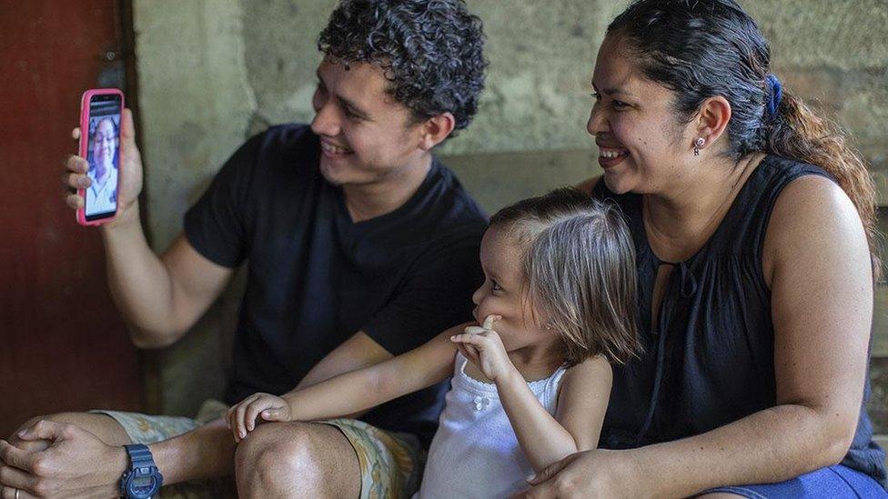 A family in Nicaragua speaking to a therapist on an iPhone