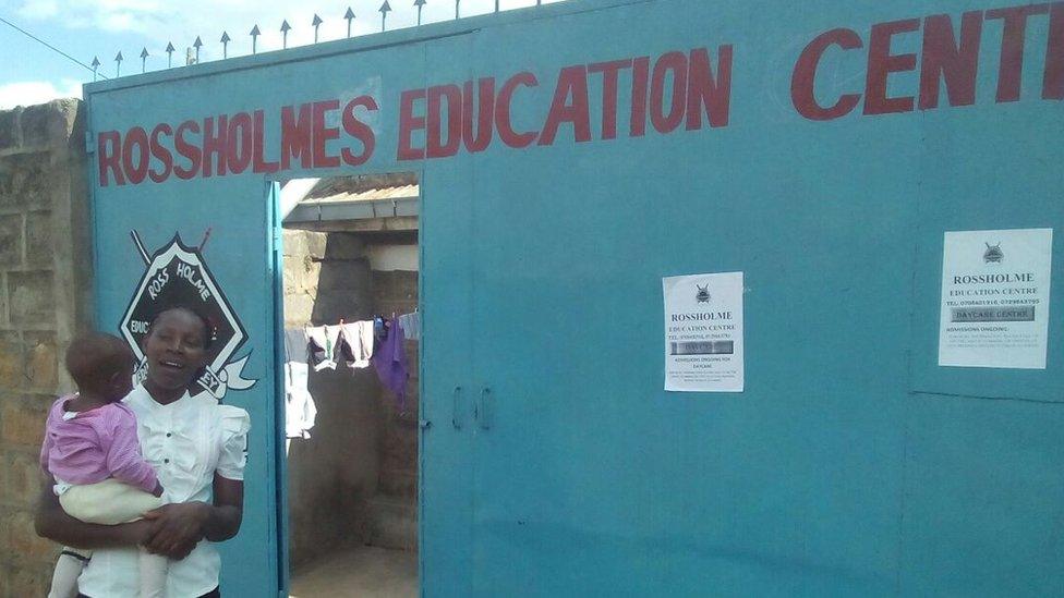 Joyce Aruga standing outside the gates of her newly opened Rossholme Education Centre