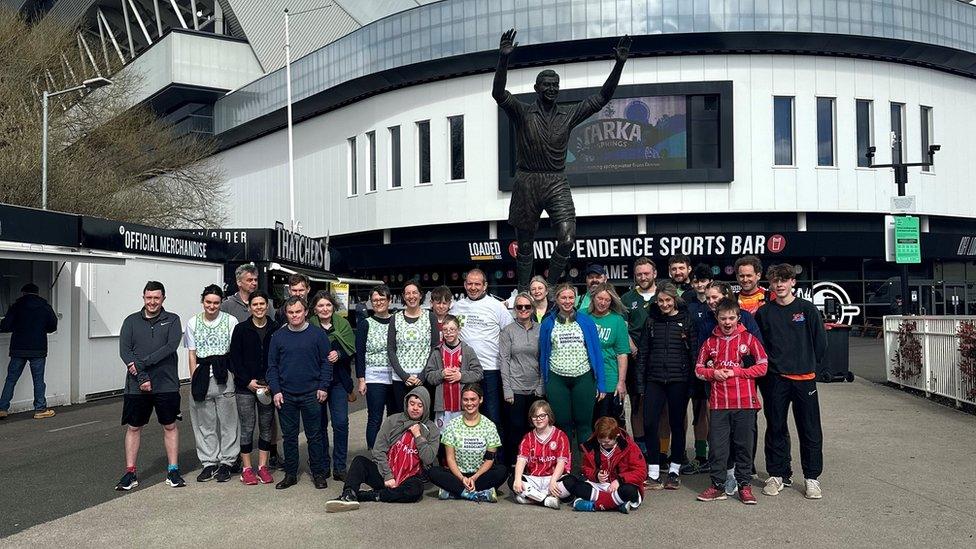 A group of runners pose for a picture.