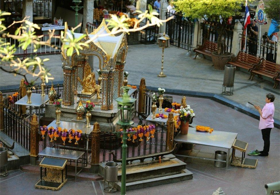 A woman prays to Hindu god Brahma at the sacred Erawan Shrine, hours before it will reopen to the public, two days after a bomb detonated on 17 August, in central Bangkok, Thailand, 19 August 2015