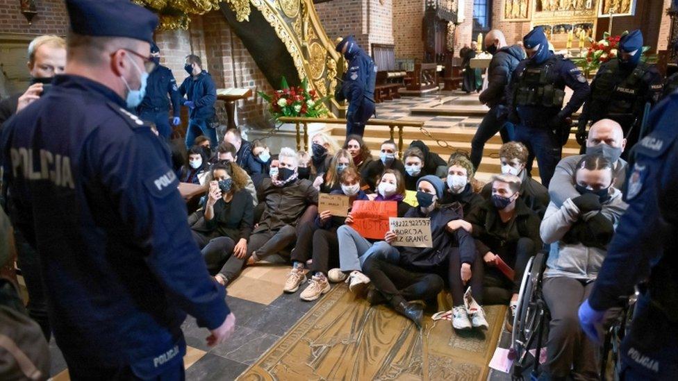 Protesters stage a sit-in at the Archcathedral Basilica of St Peter and St Paul in Poznan, Poland