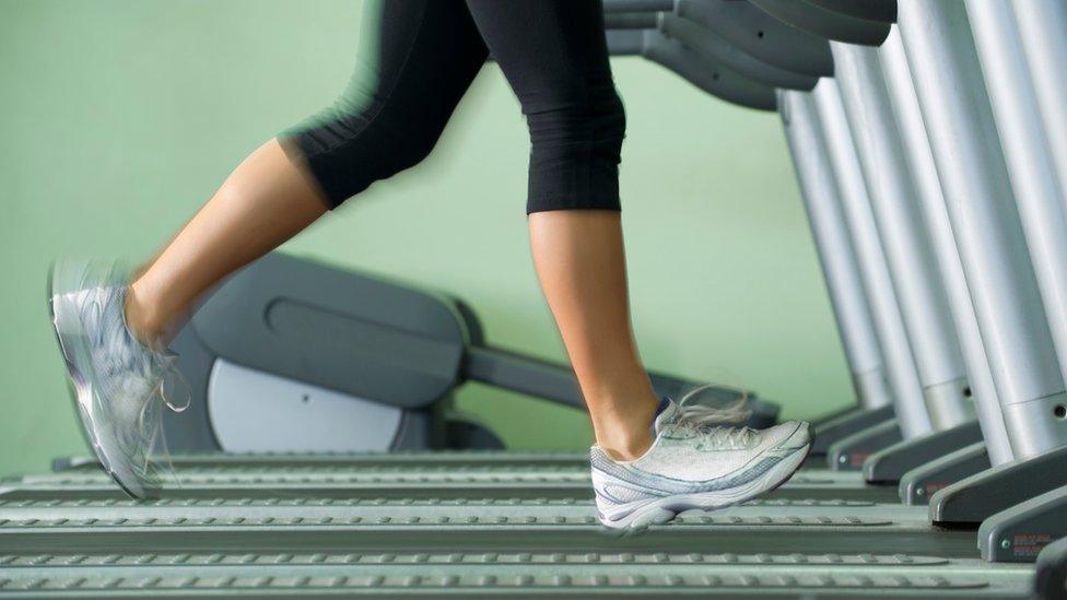 Woman running on treadmill in gym