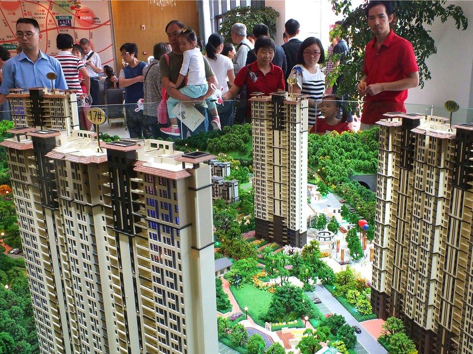 This photo taken on 1 October 2015 shows Chinese home buyers visiting a housing fair in Yichang, in China's Hubei province.