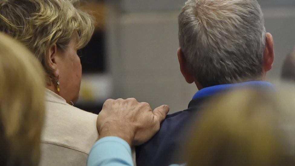 Family members of victims of those murdered in the motorcycle shop comfort one another in court during a bond hearing for Todd Kohlhepp, 6 November 2016